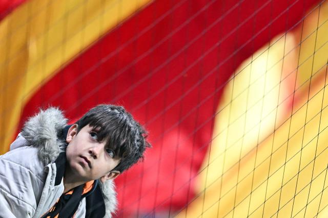 A young supporter reacts as he waits for the start of the UEFA Champions League, league phase day 7, football match between Galatasaray and Atletico Madrid at Rams Park in Istanbul, on January 21, 2026. (Photo by OZAN KOSE / AFP)