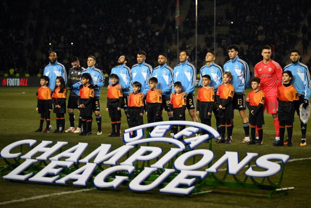 Qarabag's players line up prior to the UEFA Champions League league phase football match between Qarabag and Frankfurt at the Tofiq Bahramov Republican Stadium in Baku on January 21, 2026. (Photo by Tofik BABAYEV / AFP)