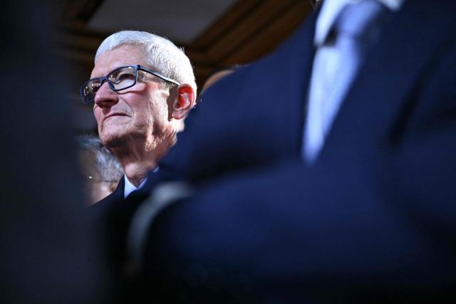 US businessman Tim Cook reacts during a reception with business leaders on the sidelines of the World Economic Forum (WEF) annual meeting in Davos on January 21, 2026. The World Economic Forum takes place in Davos from January 19 to January 23, 2026. (Photo by Mandel NGAN / AFP)