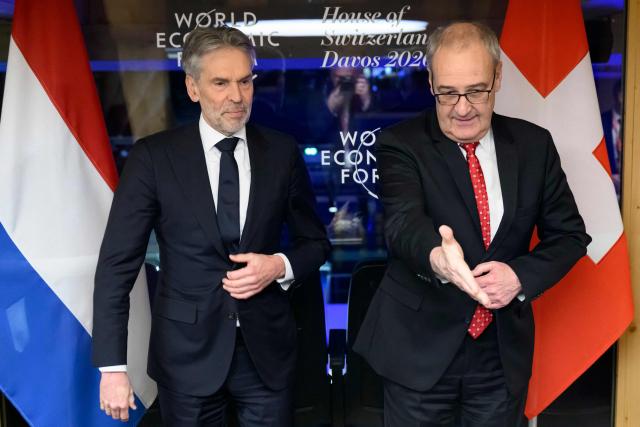 Swiss Federal President Guy Parmelin (R) and Netherlands' Prime Minister Dick Schoof (L) meet for a bilateral meeting at the House of Switzerland on the sidelines of the World Economic Forum (WEF) annual meeting in Davos on January 21, 2026. The World Economic Forum takes place in Davos from January 19 to January 23, 2026. (Photo by LAURENT GILLIERON / AFP)