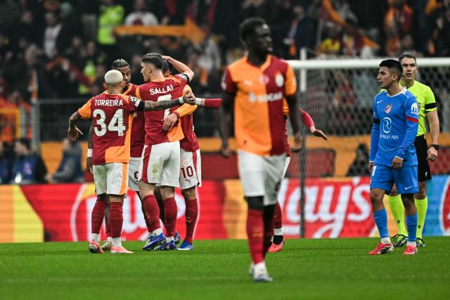 Galatasaray's players celebrate their team first goal following the own goal scored by Atletico Madrid's Spanish midfielder #14 Marcos Llorente during the UEFA Champions League, league phase day 7, football match between Galatasaray and Atletico Madrid at Rams Park in Istanbul, on January 21, 2026. (Photo by OZAN KOSE / AFP)