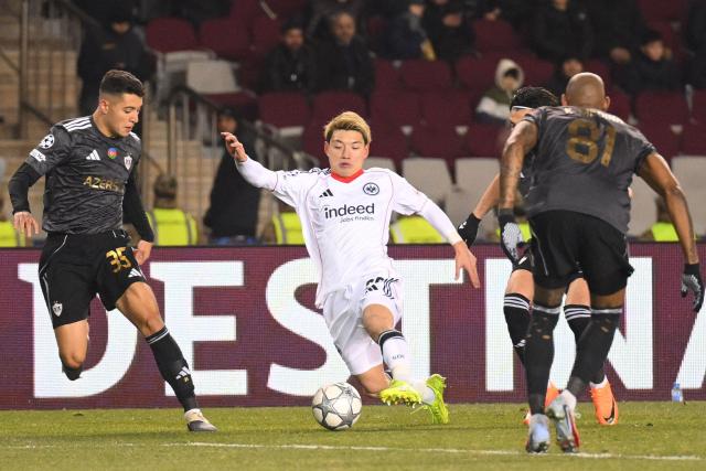 Qarabag's Brazilian midfielder Pedro Bicalho and Frankfurt's Japanese forward #20 Ritsu Doan vie for the ball during the UEFA Champions League league phase football match between Qarabag and Frankfurt at the Tofiq Bahramov Republican Stadium in Baku on January 21, 2026. (Photo by Tofik BABAYEV / AFP)