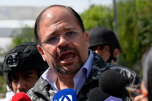 Ecuador's Interior Minister John Reimberg speaks to the press during a security operation in Quito's financial district on January 21, 2026. (Photo by Rodrigo BUENDIA / AFP)