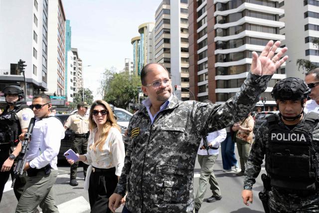 Ecuador's Interior Minister John Reimberg waves as he participates in a security operation in Quito's financial district on January 21, 2026. (Photo by Rodrigo BUENDIA / AFP)