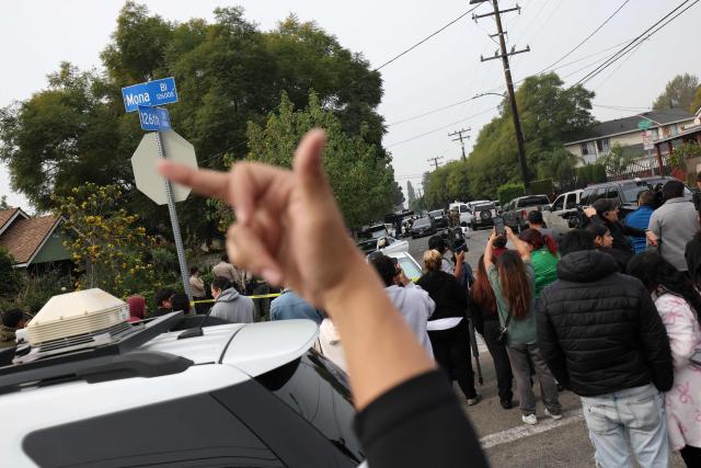 Protesters gather as federal agents investigate the scene of a reported shooting during an operation by federal immigration officers in Willowbrook, California, near Los Angeles, on January 21, 2026. According to media reports, no one was injured in the incident and suspects were arrested. Crowds of protesters have clashed with immigration officers in Minneapolis, particularly since the fatal shooting of a US woman by a federal agent on January 7. (Photo by Patrick T. Fallon / AFP)