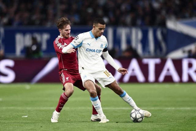 Liverpool's Argentine midfielder #10 Alexis Mac Allister (L) and Marseille's English forward #10 Mason Greenwood fight for the ball during the UEFA Champions League, league phase day 7, football match between Olympique de Marseille (OM) and Liverpool FC at the Stade Velodrome in Marseille, southern France, on January 21, 2026. (Photo by Thibaud MORITZ / AFP)