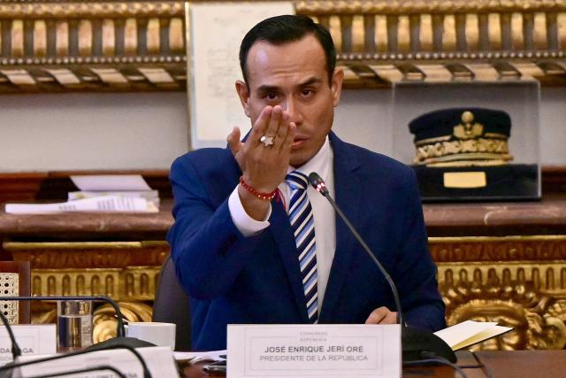 Peru's President Jose Jeri gestures during a congressional committee to testify about alleged irregularities in meetings with Chinese businessmen at the National Congress in Lima on January 21, 2026. Peru's attorney general confirmed on January 19, that he had opened a preliminary investigation into interim Peruvian president Jose Jeri for the alleged crime of influence peddling for meeting with a Chinese businessman without officially informing his collaborators. (Photo by Ernesto BENAVIDES / AFP)