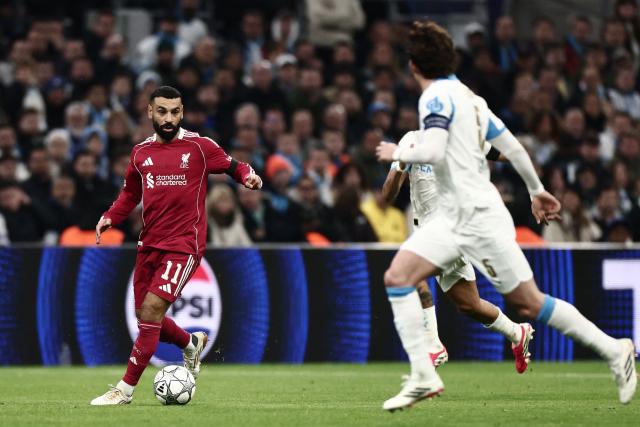 Egypt's forward #11 Mohamed Salah (L) controls the ball during the UEFA Champions League, league phase day 7, football match between Olympique de Marseille (OM) and Liverpool FC at the Stade Velodrome in Marseille, southern France, on January 21, 2026. (Photo by Thibaud MORITZ / AFP)