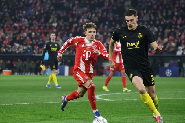 Bayern Munich's German midfielder #42 Lennart Karl (L) and Union St-Gilloise's English defender #26 Ross Sykes vie for the ball during the UEFA Champions League football match between FC Bayern Munich (GER) and Union St-Gilloise (BEL) in Munich, southern Germany, on January 21, 2026. (Photo by Karl-Josef HILDENBRAND / AFP)