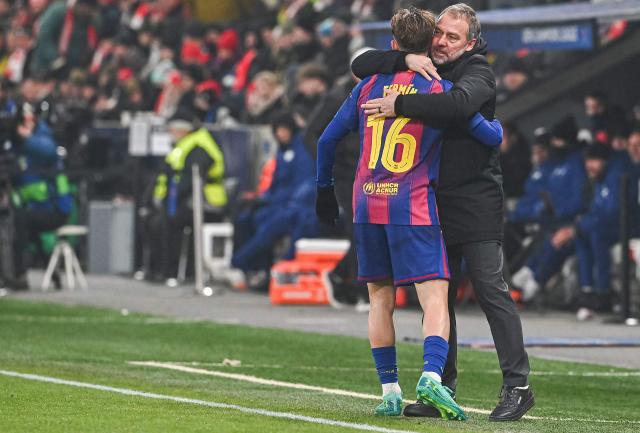 Barcelona's Spanish midfielder #16 Fermin Lopez celebrates with Barcelona's German coach Hans-Dieter Flick after scoring during in the UEFA Champions League football match between Slavia Prague (CZE) and FC Barcelona (ESP) in Prague, Czech Republic on January  21, 2026. (Photo by Michal Cizek / AFP)