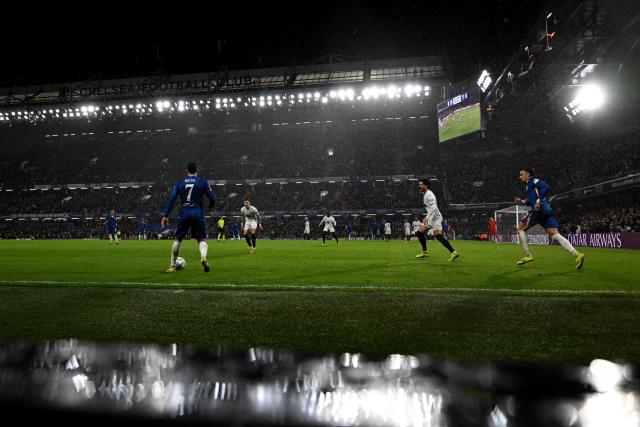 Chelsea's Portuguese midfielder #07 Pedro Neto controls the ball whilst rain falls during the UEFA Champions League league-phase football match between Chelsea and Pafos at Stamford Bridge in London on January 21, 2026. (Photo by Glyn KIRK / AFP)