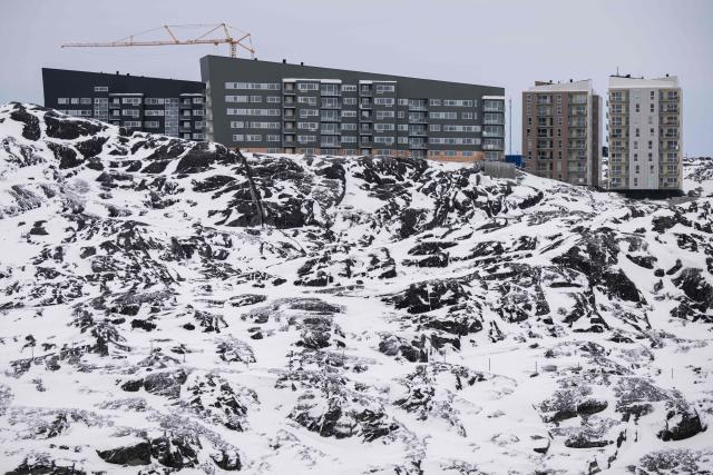 Newly built apartment blocks stand on a snow-covered hillside overlooking Nuuk, Greenland, on January 21, 2026. (Photo by Jonathan NACKSTRAND / AFP)
