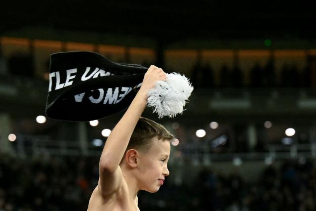 A young fan waves a scarf after the UEFA Champions League league-phase football match between Newcastle United and PSV Eindhoven at St James' Park in Newcastle-upon-Tyne, north-east England on January 21, 2026. (Photo by Oli SCARFF / AFP)