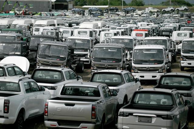 New cars and trucks are parked at a free trade zone in Yumbo, near Cali, Colombia on January 21, 2026. Ecuador's President Daniel Noboa on January 21, 2026, announced 30-percent tariffs on imports from Colombia, accusing its neighbor of failing to help fight drug cartels. Colombia mainly exports electricity, medicines, vehicles, cosmetics, and plastics to Ecuador, according to Colombia's National Foreign Trade Association (Analdex). (Photo by Joaquín SARMIENTO / AFP)