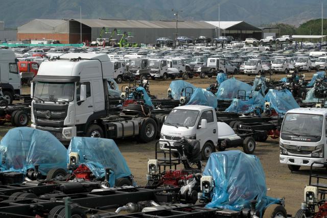 New cars and trucks are parked at a free trade zone in Yumbo, near Cali, Colombia on January 21, 2026. Ecuador's President Daniel Noboa on January 21, 2026, announced 30-percent tariffs on imports from Colombia, accusing its neighbor of failing to help fight drug cartels. Colombia mainly exports electricity, medicines, vehicles, cosmetics, and plastics to Ecuador, according to Colombia's National Foreign Trade Association (Analdex). (Photo by Joaquín SARMIENTO / AFP)
