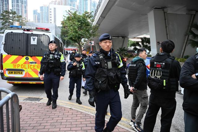 Police arrive at the West Kowloon Magistrates' court in Hong Kong on January 22, 2026, for the start of the trial of the now-disbanded Hong Kong Alliance with among the defendants three of its leaders, Chow Hang-tung, Albert Ho and LEE Cheuk-yan who for years organised the annual vigil for the victims of the Tiananmen Square massacre in 1989. (Photo by Peter PARKS / AFP)