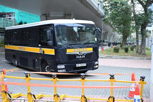 A police van arrives at the West Kowloon Magistrates' court in Hong Kong on January 22, 2026, for the start of the trial of the now-disbanded Hong Kong Alliance with among the defendants three of its leaders, Chow Hang-tung, Albert Ho and LEE Cheuk-yan who for years organised the annual vigil for the victims of the Tiananmen Square massacre in 1989. (Photo by Peter PARKS / AFP)
