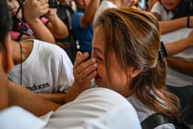 Lala Cumpio, mother of the detained Filipino journalist Frenchie Mae Cumpio, cries outside the Tacloban Regional Trial Court in Leyte island on January 22, 2026, after the promulgation of her daughter's court case. Cumpio, who spent nearly six years in a crowded provincial prison, was found guilty of terror financing in a case rights groups and a UN rapporteur had labelled a "travesty of justice". (Photo by Jam STA ROSA / AFP)