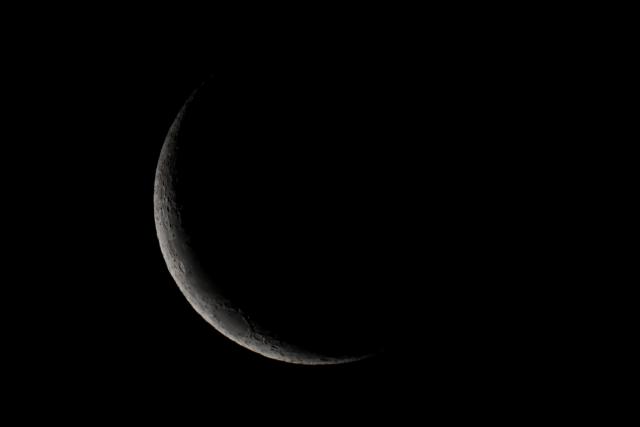 The waxing crescent moon is seen in Buenos Aires on January 21, 2026. (Photo by Luis ROBAYO / AFP)