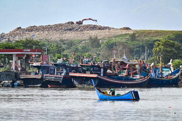 A fishermen boat returns to port in Banda Aceh on January 22, 2026. (Photo by CHAIDEER MAHYUDDIN / AFP)