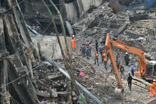 Rescue personnel clear debris of a shopping mall in Karachi on January 22, 2026, after a massive fire broke out on January 17. The death toll from a mall fire in Pakistan's biggest city rose to at least 55 people, a Karachi government official told AFP on January 22. (Photo by Asif HASSAN / AFP)