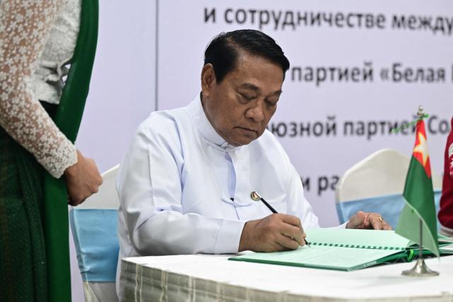 The Union Solidarity and Development Party (USDP) chairman U Khin Yi signs a cooperation agreement with Olga Chemodanova, newly elected chairperson of Belarusian political party Belaya Rus, during a ceremony at the Sky Star Hotel in Yangon on January 22, 2026. (Photo by AFP)