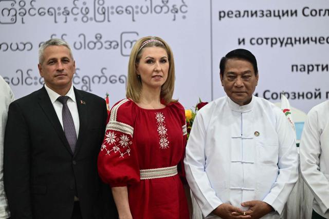 The Union Solidarity and Development Party (USDP) chairman U Khin Yi (R) and Olga Chemodanova (C), newly elected chairperson of Belarusian political party Belaya Rus pose for photo during a ceremony to sign a cooperation agreement at the Sky Star Hotel in Yangon on January 22, 2026. (Photo by AFP)