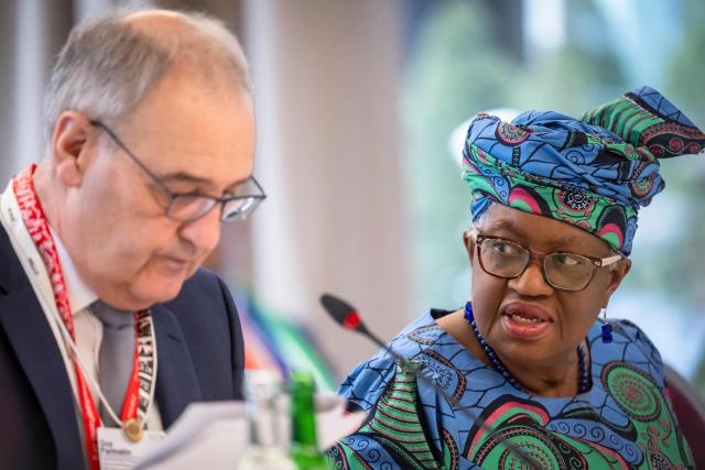 World Trade Organization’s Director-General Ngozi Okonjo-Iweala (R) looks at Switzerland's President Guy Parmelin during a World Trade Organization (WTO) Informal ministerial gathering on the sidelines of the World Economic Forum (WEF) annual meeting in Davos on January 22, 2026. The World Economic Forum takes place in Davos from January 19 to January 23, 2026. (Photo by LAURENT GILLIERON / POOL / AFP)