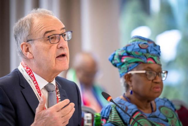 Switzerland's President Guy Parmelin (L) speaks next to World Trade Organization’s Director-General Ngozi Okonjo-Iweala during a World Trade Organization (WTO) Informal ministerial gathering on the sidelines of the World Economic Forum (WEF) annual meeting in Davos on January 22, 2026. The World Economic Forum takes place in Davos from January 19 to January 23, 2026. (Photo by LAURENT GILLIERON / POOL / AFP)