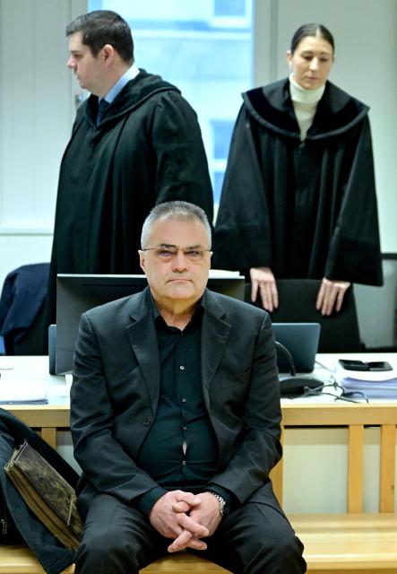 Austrian former intelligence official Egisto Ott sits with his lawyers Anna Mair and Michael Ofner (L) behind him in the courtroom at the start of his trial in the criminal court in Vienna, Austria, on January 22, 2026, harged with handing over sensitive devices and selling secret information to Russia. The trial is the latest to stem from a sprawling case that broke in 2024 and centres on former agent Egisto Ott. The 63-year-old faces a slew of charges including suspected abuse of office, corruption and espionage to the detriment of Austria. He has denied the accusations. (Photo by ROLAND SCHLAGER / APA / AFP) / Austria OUT
