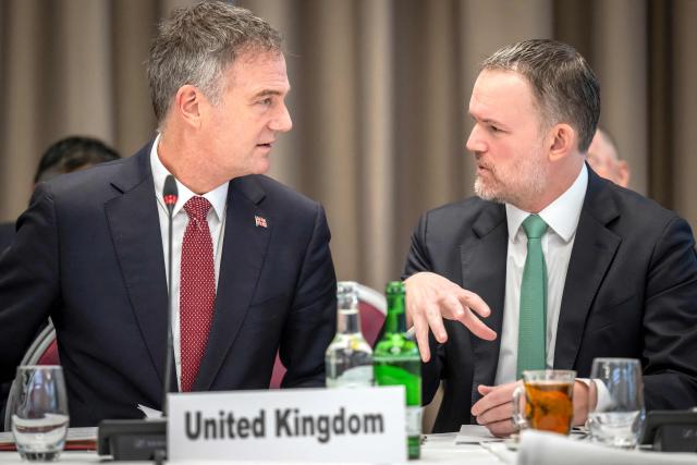 Britain's Business Secretary Peter Kyle (L) speaks with US Trade Representative Jamieson Greer during a World Trade Organization (WTO) Informal ministerial gathering on the sidelines of the World Economic Forum (WEF) annual meeting in Davos on January 22, 2026. The World Economic Forum takes place in Davos from January 19 to January 23, 2026. (Photo by LAURENT GILLIERON / POOL / AFP)
