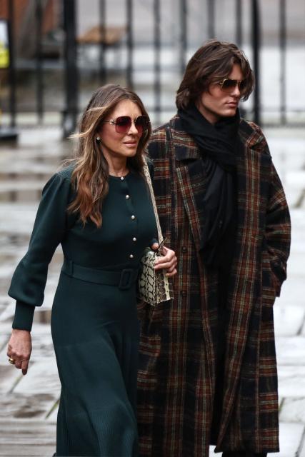 British actress Elizabeth Hurley (L) arrives with her son Damian Hurley outside the High Court in London on January 22, 2026, for the fourth day of the trial of Hurley and six other high-profile complainants against a major UK newspaper group. Prince Harry, Hurley and five others, including pop icon Elton John, accuse two tabloids of privacy invasions and unlawful information gathering, in the prince's last active legal case in his long-running crusade against some UK media. (Photo by HENRY NICHOLLS / AFP)