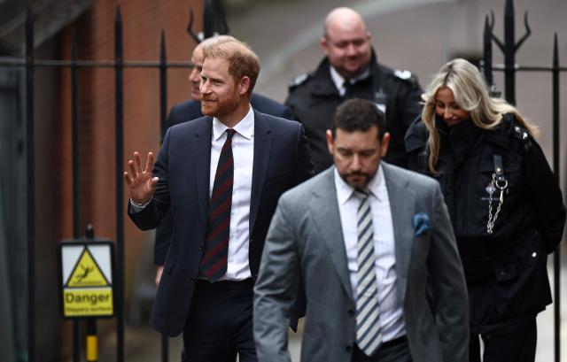 Britain's Prince Harry, Duke of Sussex, waves as he arrives outside the The Royal Courts of Justice, Britain's High Court, in London on January 22, 2026, for the fourth day the trial in his case against a major UK newspaper group. Prince Harry and six others, including pop icon Elton John, accuse two tabloids of privacy invasions and unlawful information gathering, in the prince's last active legal case in his long-running crusade against some UK media. (Photo by Henry NICHOLLS / AFP)