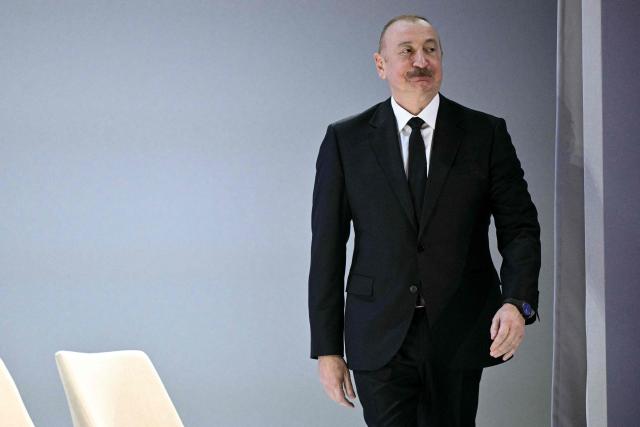 Azerbaijan's President Ilham Aliyev arrives to attend the "Board of Peace" meeting during the World Economic Forum (WEF) annual meeting in Davos on January 22, 2026. US President Donald Trump will show off his new "Board of Peace" at Davos on January 22, 2026 burnishing his claim to be a peacemaker a day after backing off his own threats against Greenland. Originally meant to oversee the rebuilding of Gaza after the war between Hamas and Israel, the board's charter does not limit its role to the Strip, and has sparked concerns that Trump wants it to rival the United Nations. (Photo by Mandel NGAN / AFP)
