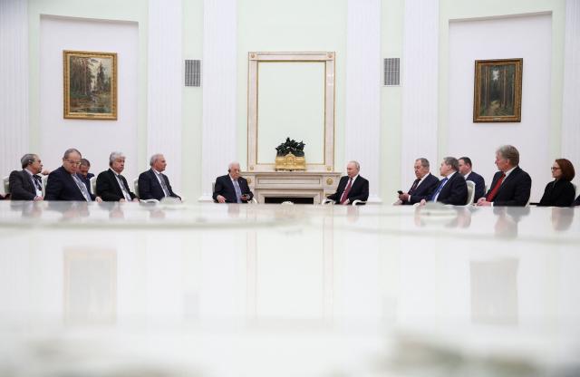 Russian President Vladimir Putin and Palestinian President Mahmoud Abbas hold a meeting at the Kremlin in Moscow on January 22, 2026. (Photo by Ramil Sitdikov / POOL / AFP)