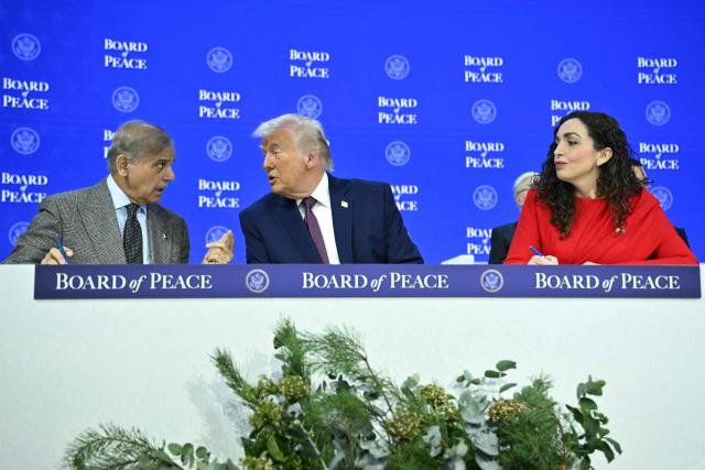 Pakistan's Prime Minister Shehbaz Sharif (L) and Kosovo's President Vjosa Osmani speak with US President Donald Trump at the "Board of Peace" meeting during the World Economic Forum (WEF) annual meeting in Davos on January 22, 2026. US President Donald Trump will show off his new "Board of Peace" at Davos on January 22, 2026 burnishing his claim to be a peacemaker a day after backing off his own threats against Greenland. Originally meant to oversee the rebuilding of Gaza after the war between Hamas and Israel, the board's charter does not limit its role to the Strip, and has sparked concerns that Trump wants it to rival the United Nations. (Photo by Mandel NGAN / AFP)