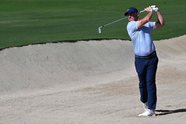Rory McIlroy of Northern Ireland plays a second shot on the 6th hole during the first day of the Hero Dubai Desert Classic golf tournament at the Emirates Golf Club in Dubai on January 22, 2026. (Photo by Giuseppe CACACE / AFP)