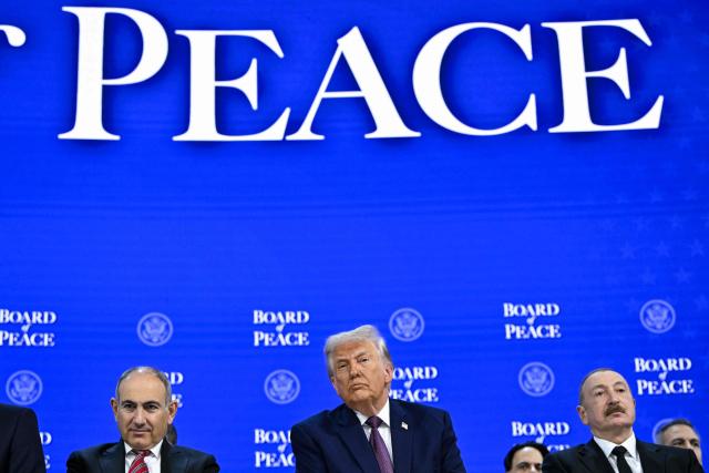Armenia's Prime Minister Nikol Pashinyan (L), US President Donald Trump (C) and Azerbaijan's President Ilham Aliyev attend the "Board of Peace" meeting during the World Economic Forum (WEF) annual meeting in Davos on January 22, 2026. US President Donald Trump will show off his new "Board of Peace" at Davos on January 22, 2026 burnishing his claim to be a peacemaker a day after backing off his own threats against Greenland. Originally meant to oversee the rebuilding of Gaza after the war between Hamas and Israel, the board's charter does not limit its role to the Strip, and has sparked concerns that Trump wants it to rival the United Nations. (Photo by Mandel NGAN / AFP)