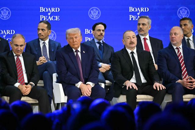 (From L) Armenia's Prime Minister Nikol Pashinyan, Qatar's Prime Minister Sheikh Mohammed bin Abdulrahman bin Jassim al-Thani , US President Donald Trump, Saudi Arabia's Foreign Minister Faisal bin Farhan, Azerbaijan's President Ilham Aliyev, Turkey's Foreign Minister Hakan Fidan, and Bulgaria's former Prime Minister Rosen Zhelyazkov look on at the "Board of Peace" meeting during the World Economic Forum (WEF) annual meeting in Davos on January 22, 2026. US President Donald Trump will show off his new "Board of Peace" at Davos on January 22, 2026 burnishing his claim to be a peacemaker a day after backing off his own threats against Greenland. Originally meant to oversee the rebuilding of Gaza after the war between Hamas and Israel, the board's charter does not limit its role to the Strip, and has sparked concerns that Trump wants it to rival the United Nations. (Photo by Fabrice COFFRINI / AFP)