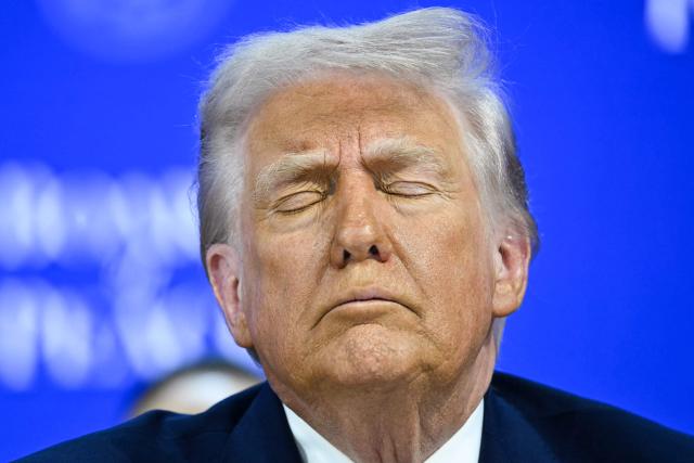 US President Donald Trump reacts at the "Board of Peace" meeting during the World Economic Forum (WEF) annual meeting in Davos on January 22, 2026. US President Donald Trump will show off his new "Board of Peace" at Davos on January 22, 2026 burnishing his claim to be a peacemaker a day after backing off his own threats against Greenland. Originally meant to oversee the rebuilding of Gaza after the war between Hamas and Israel, the board's charter does not limit its role to the Strip, and has sparked concerns that Trump wants it to rival the United Nations. (Photo by Mandel NGAN / AFP)