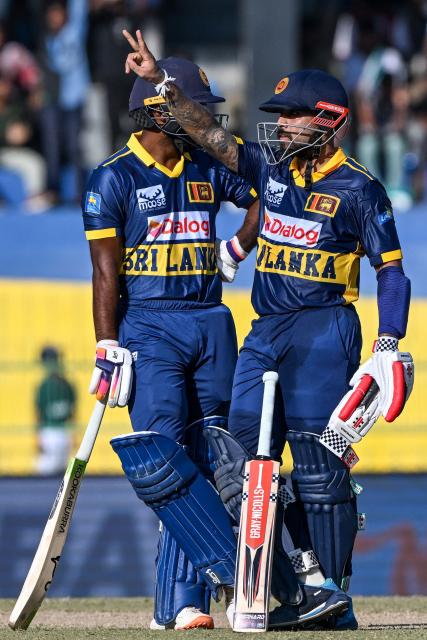 Sri Lanka's Kusal Mendis (R) celebrates after scoring a half-century (50 runs) during the first one-day international (ODI) cricket match between Sri Lanka and England at the R. Premadasa International Cricket Stadium in Colombo on January 22, 2026. (Photo by Ishara S. KODIKARA / AFP)