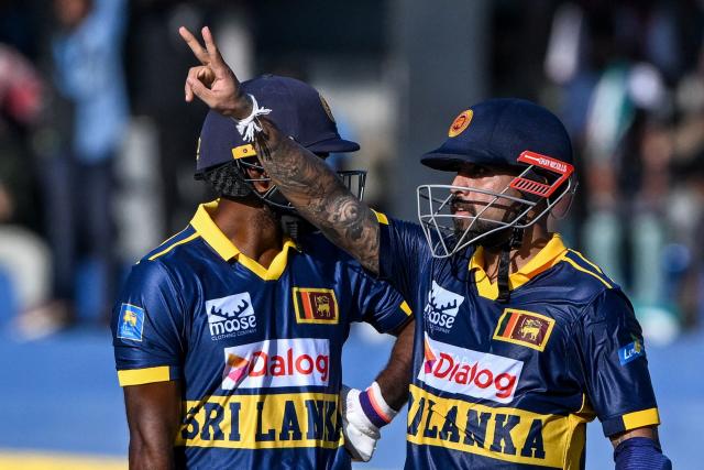 Sri Lanka's Kusal Mendis (R) celebrates after scoring a half-century (50 runs) during the first one-day international (ODI) cricket match between Sri Lanka and England at the R. Premadasa International Cricket Stadium in Colombo on January 22, 2026. (Photo by Ishara S. KODIKARA / AFP)