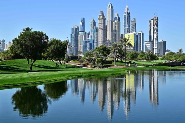 A view of the Emirates Golf Club is pictured against the backdrop of Dubai Marina during the Hero Dubai Desert Classic golf tournament in Dubai on January 22, 2026. (Photo by Giuseppe CACACE / AFP)