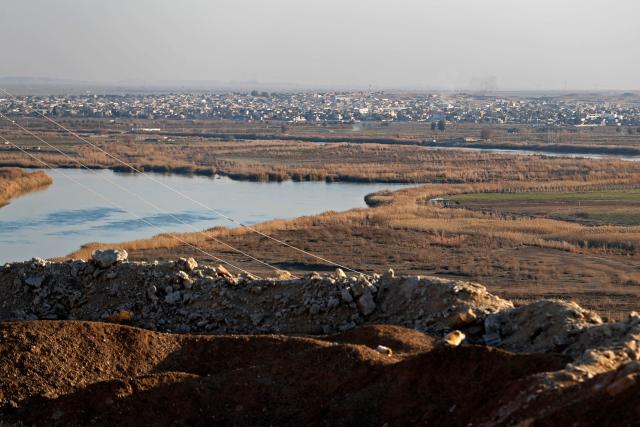 This photograph shows a view of the Al-Baghuz Fawqani village in the Abu Kamal region of Syria, along the border with the Iraqi city of Al-Qaim, west of Baghdad on January 21, 2026. The Iraqi judiciary on January 22 announced it would launch legal proceedings against Islamic State group detainees transferred from Syria to Iraq as part of a US operation. The US military said on January 21 it had launched an operation to move 7,000 IS prisoners from Syria to Iraq, as Syrian government forces moved on facilities long secured by Kurdish-led forces in Syria. (Photo by AHMAD AL-RUBAYE / AFP)