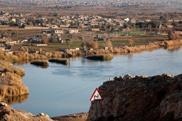 This photograph shows a view of the Al-Baghuz Fawqani village in the Abu Kamal region of Syria, along the border with the Iraqi city of Al-Qaim, west of Baghdad on January 21, 2026. The Iraqi judiciary on January 22 announced it would launch legal proceedings against Islamic State group detainees transferred from Syria to Iraq as part of a US operation. The US military said on January 21 it had launched an operation to move 7,000 IS prisoners from Syria to Iraq, as Syrian government forces moved on facilities long secured by Kurdish-led forces in Syria. (Photo by AHMAD AL-RUBAYE / AFP)