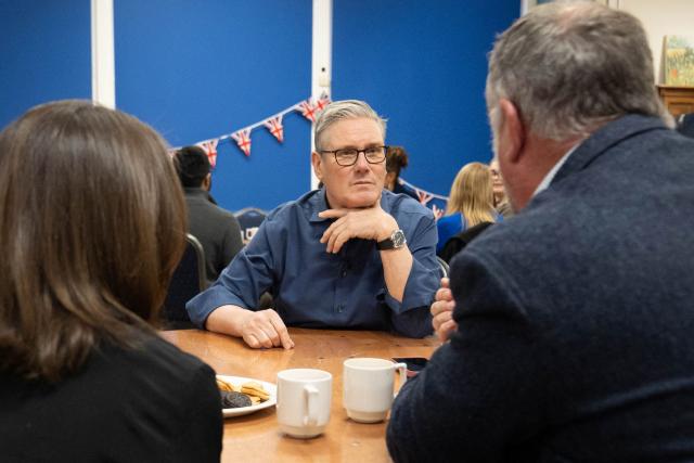Britain's Prime Minister Keir Starmer meets with local residents to discuss the government's Warm Homes Plan, during a visit to a community group at the Flaunden Village Hall near Hemel Hempstead, Hertfordshire, north of London on January 22, 2026. (Photo by Stefan Rousseau / POOL / AFP)