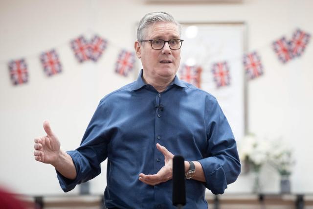 Britain's Prime Minister Keir Starmer meets with local residents to discuss the government's Warm Homes Plan, during a visit to a community group at the Flaunden Village Hall near Hemel Hempstead, Hertfordshire, north of London on January 22, 2026. (Photo by Stefan Rousseau / POOL / AFP)