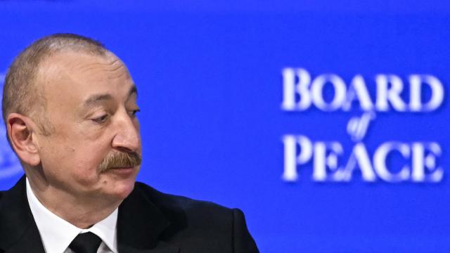 Azerbaijan's President Ilham Aliyev looks on at the "Board of Peace" meeting during the World Economic Forum (WEF) annual meeting in Davos on January 22, 2026. US President Donald Trump will show off his new "Board of Peace" at Davos on January 22, 2026 burnishing his claim to be a peacemaker a day after backing off his own threats against Greenland. Originally meant to oversee the rebuilding of Gaza after the war between Hamas and Israel, the board's charter does not limit its role to the Strip, and has sparked concerns that Trump wants it to rival the United Nations. (Photo by Fabrice COFFRINI / AFP)