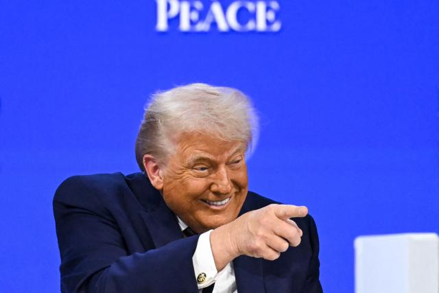 TOPSHOT - US President Donald Trump gestures as he speaks at the "Board of Peace" meeting during the World Economic Forum (WEF) annual meeting in Davos on January 22, 2026. US President Donald Trump will show off his new "Board of Peace" at Davos on January 22, 2026 burnishing his claim to be a peacemaker a day after backing off his own threats against Greenland. Originally meant to oversee the rebuilding of Gaza after the war between Hamas and Israel, the board's charter does not limit its role to the Strip, and has sparked concerns that Trump wants it to rival the United Nations. (Photo by Fabrice COFFRINI / AFP)