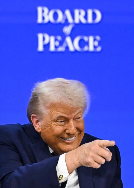 TOPSHOT - US President Donald Trump gestures as he speaks at the "Board of Peace" meeting during the World Economic Forum (WEF) annual meeting in Davos on January 22, 2026. US President Donald Trump will show off his new "Board of Peace" at Davos on January 22, 2026 burnishing his claim to be a peacemaker a day after backing off his own threats against Greenland. Originally meant to oversee the rebuilding of Gaza after the war between Hamas and Israel, the board's charter does not limit its role to the Strip, and has sparked concerns that Trump wants it to rival the United Nations. (Photo by Fabrice COFFRINI / AFP)